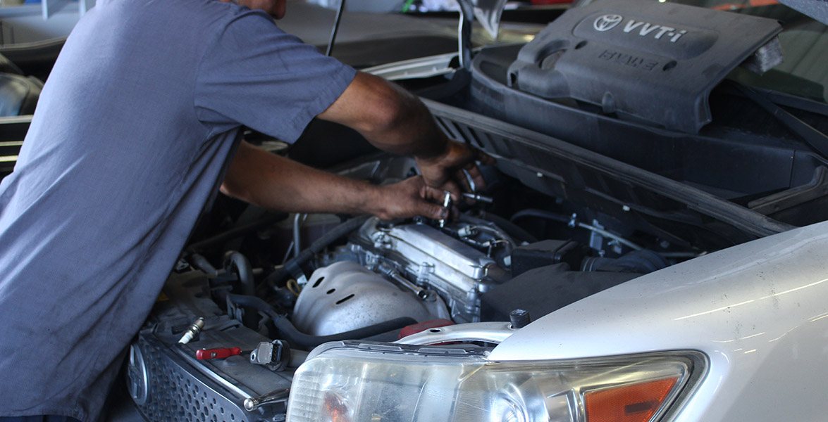 Technician working under a hood